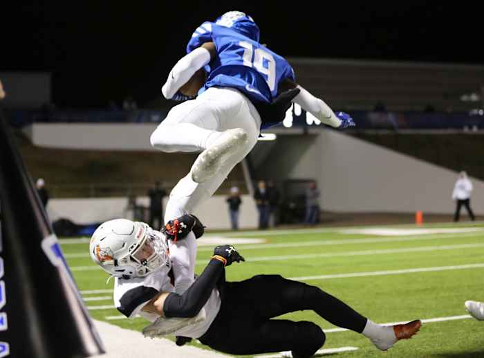 Midlothian's Bryant Wesco (5-star Clemson commit) evades a tackler on the sideline.
